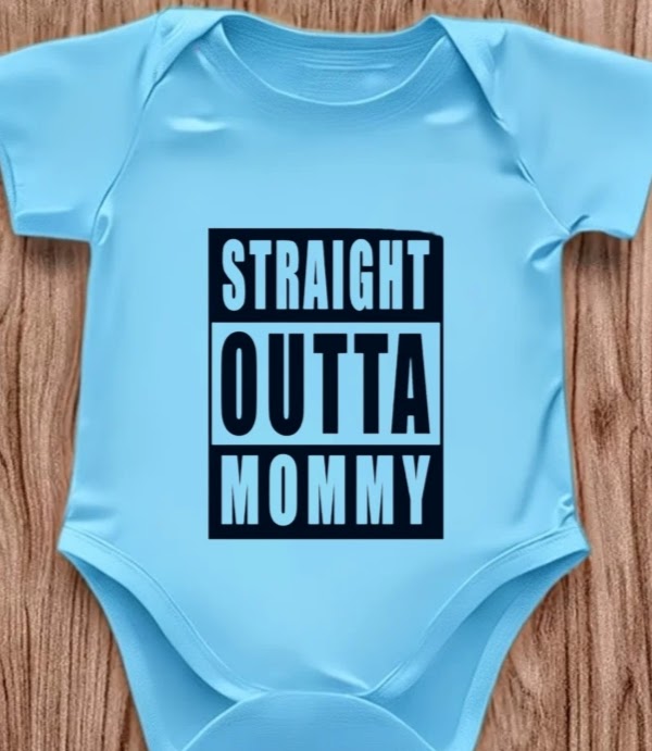 Funny baby onesie with the text 'Straight Outta Mommy' on a wooden background