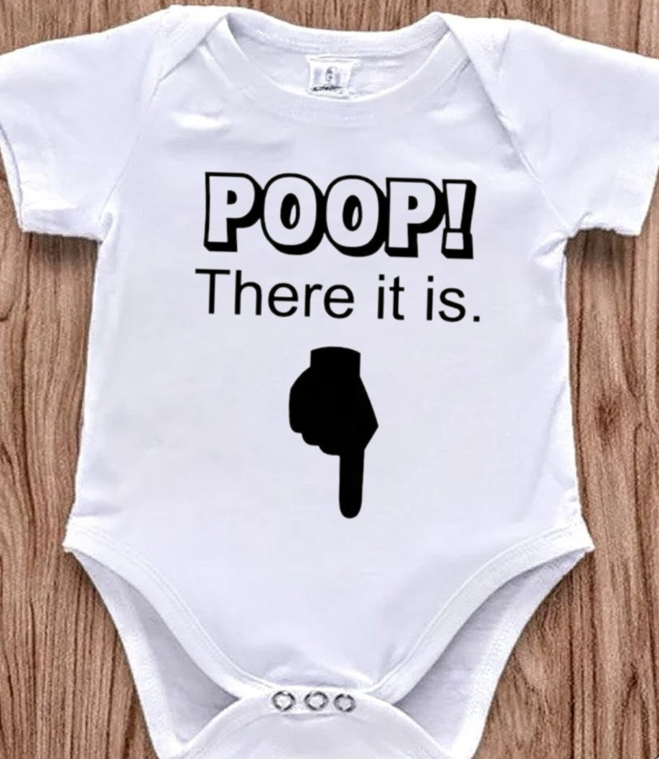 Funny baby onesie with the text 'Poop! There it is' on a wooden background